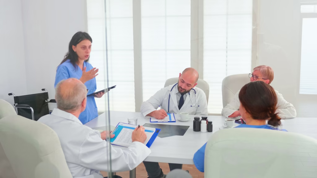 Clinician presenting a plan to her practice team in a meeting room